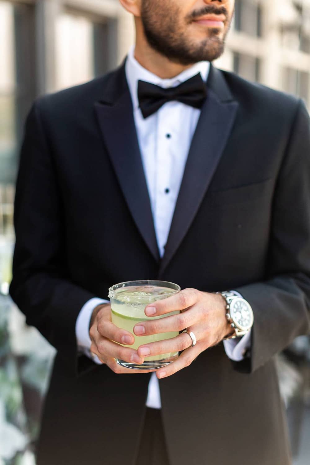 Man hold margarita at Chicago rooftop event venue The Penthouse Hyde Park