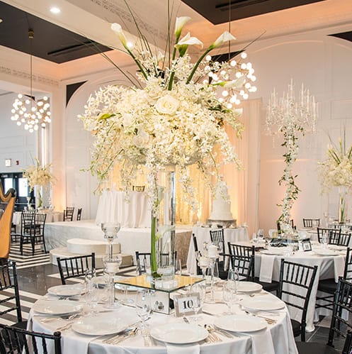 Tall white floral centerpiece at Chicago wedding venue The Penthouse Hyde Park